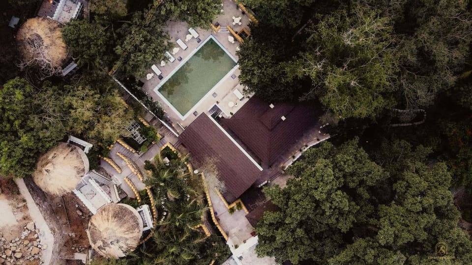 Aerial view of the pool and wooded grounds at The Aodhi
