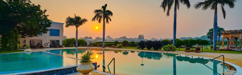 The swimming pool at sunset at The LaLiT Temple View