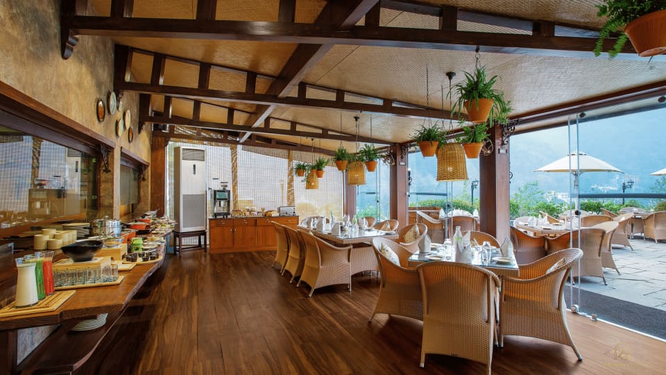 Restaurant seating beside wide windows at Aloha on the Ganges