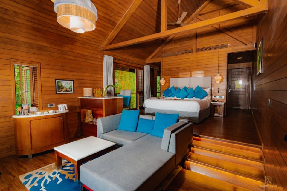 The wooden interior of a guest cottage at The Tamara Coorg