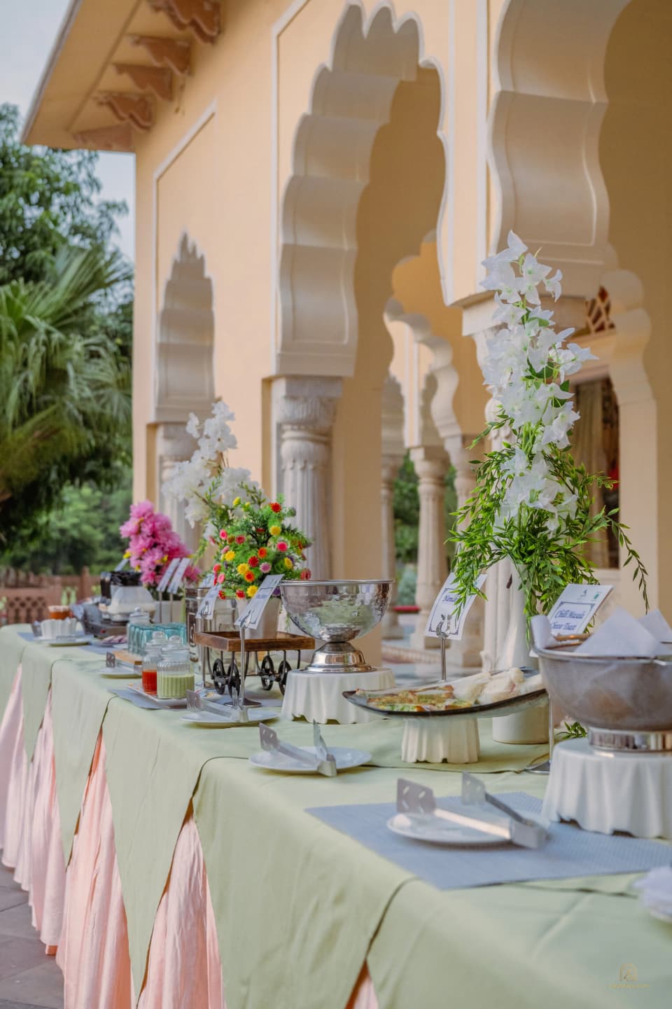A dining table beneath the palace arches