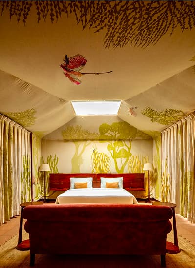 A tent bedroom with painted walls at RAAS Chhatrasagar