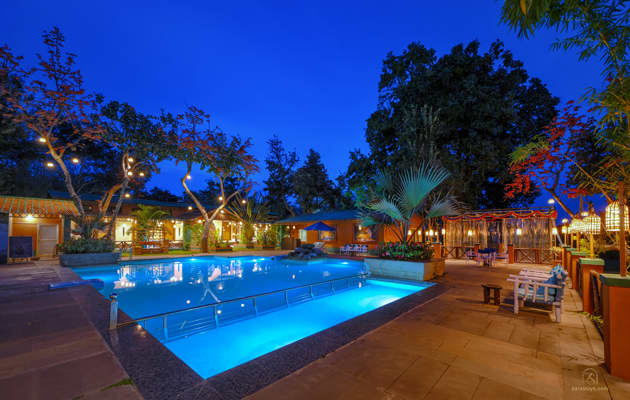 The swimming pool at Nature Heritage Resort after dusk