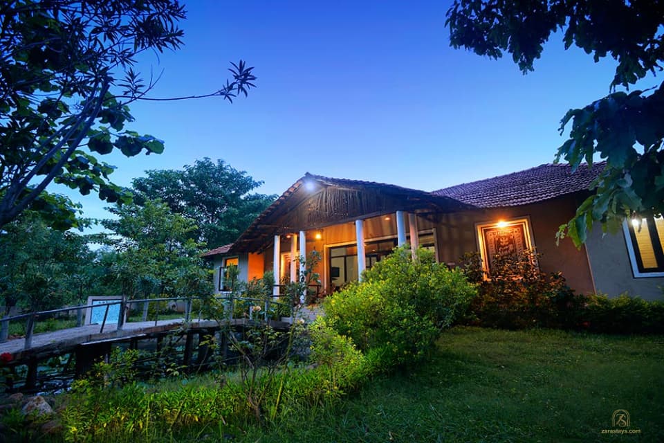A cottage lit at dusk at Chitvan Jungle Lodge