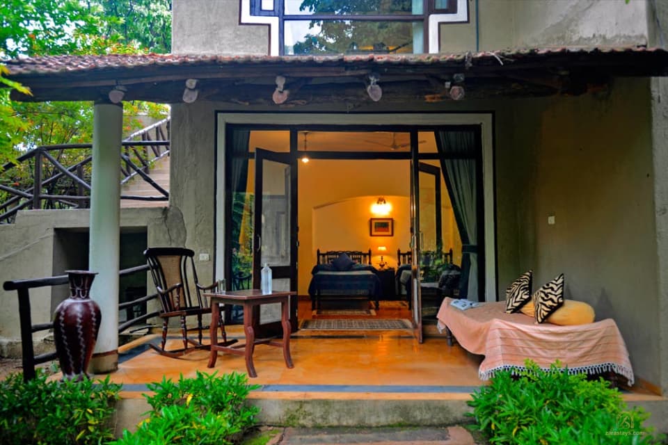 A guest room and veranda at Chitvan Jungle Lodge