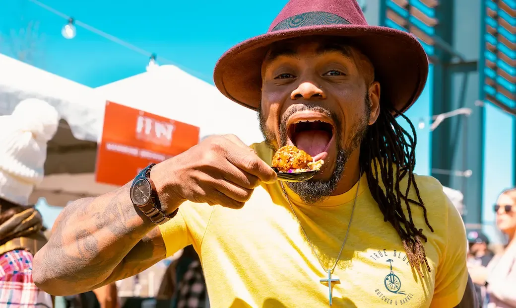 man eating bite of delicious food