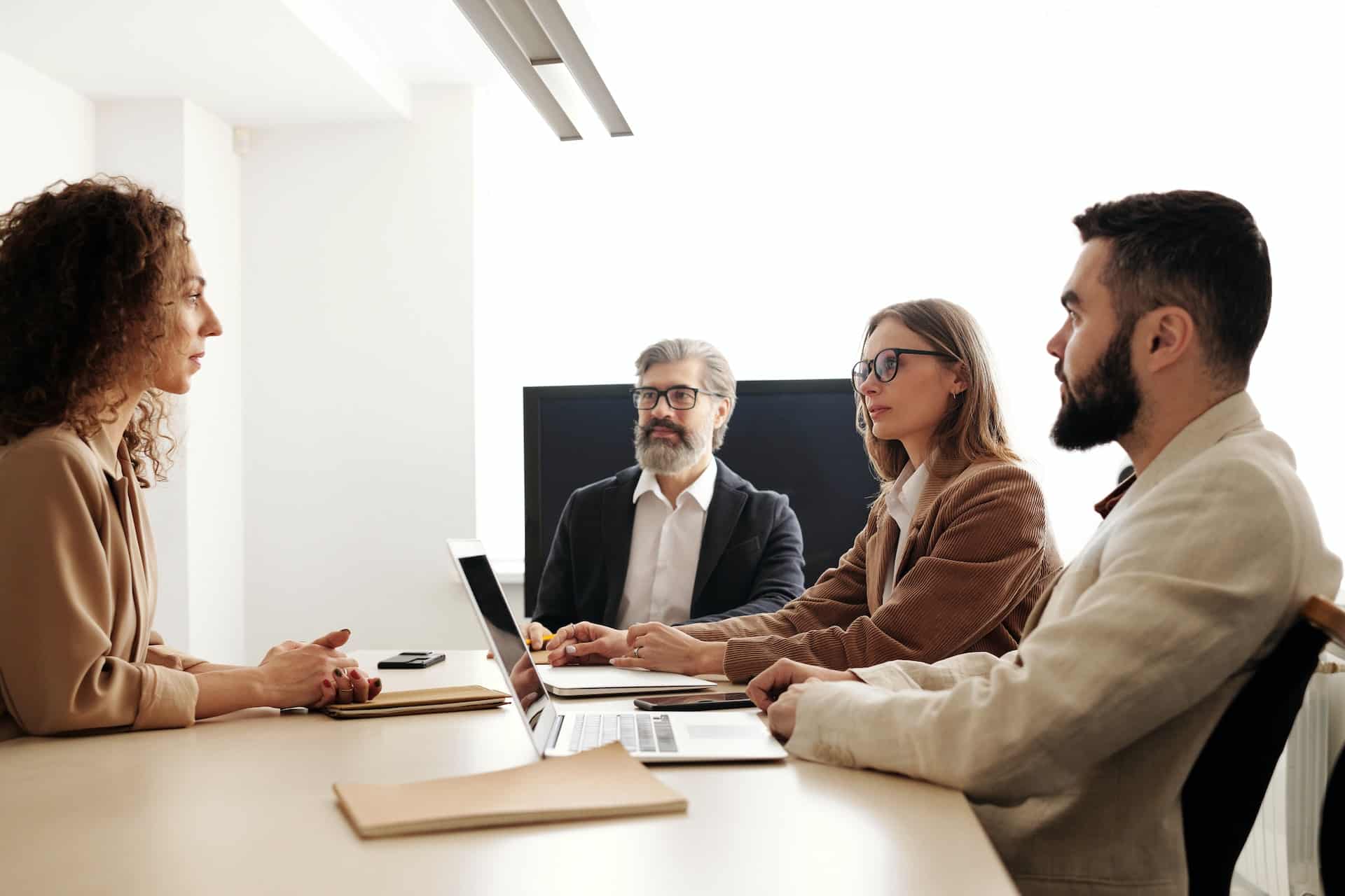 A woman facing a three-person panel in a bad interview experience