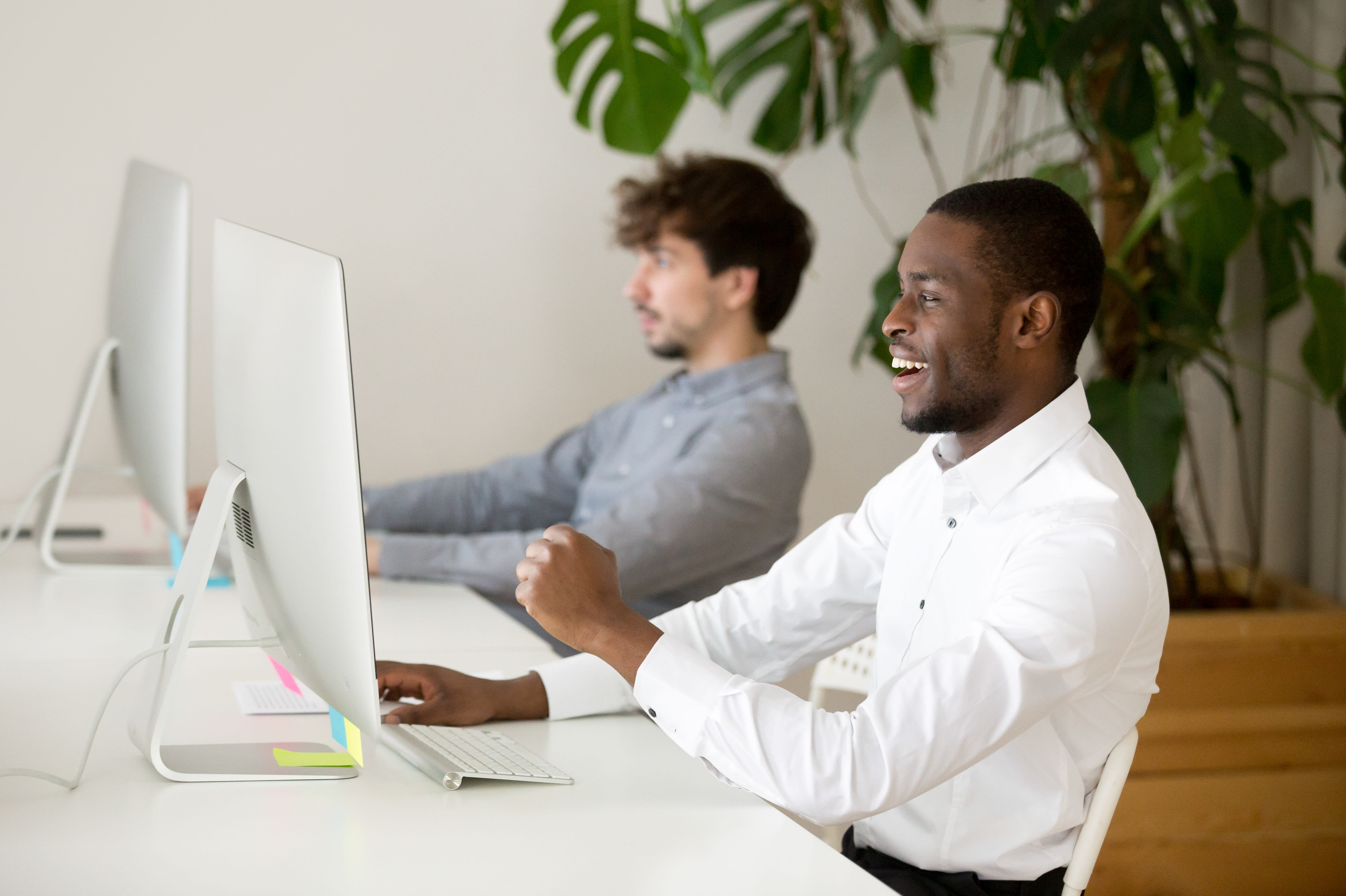happy-black-employee-excited-by-online-win-good-result.jpg