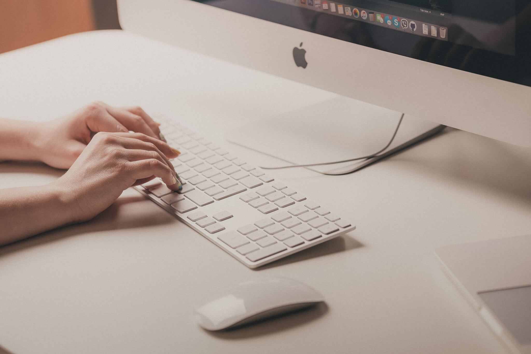 woman's hand, typing on computer keyboard