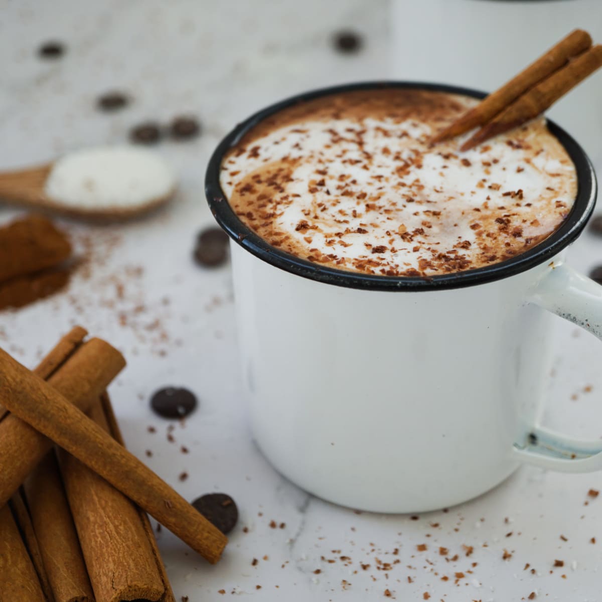 vegan hot chocolate with coconut whipped cream, cinnamon and chocolate shavings