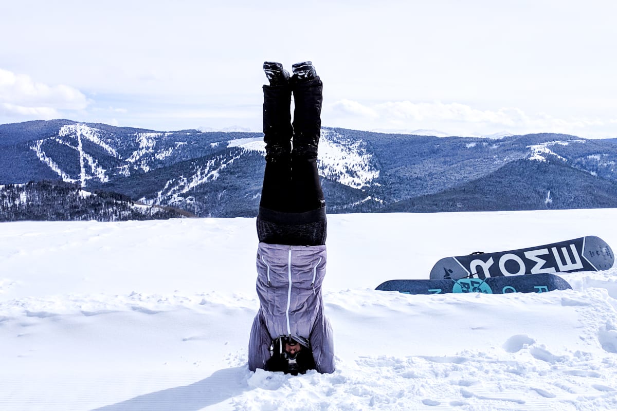 practicing a head stand in the snow