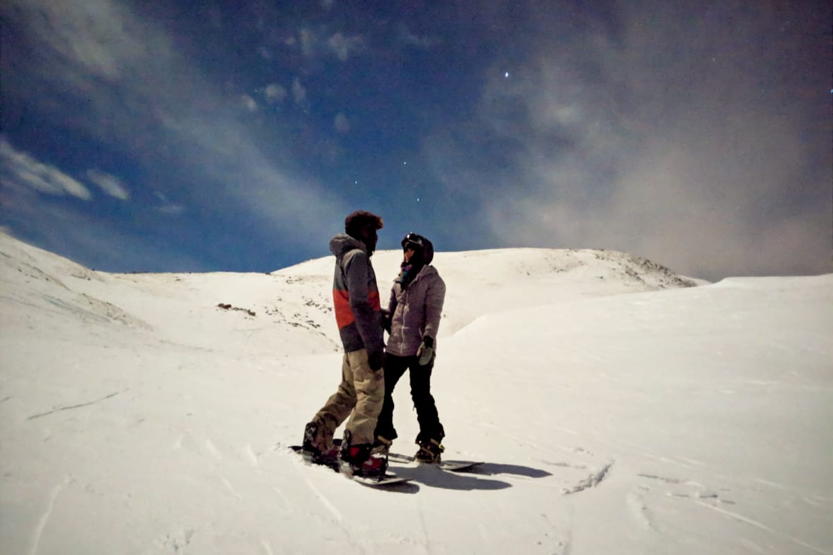 the two of us snowboarding under the full moon light