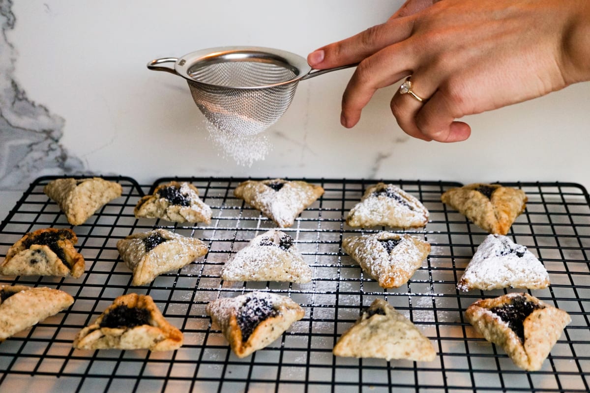 dusting sugar on the hamantaschen