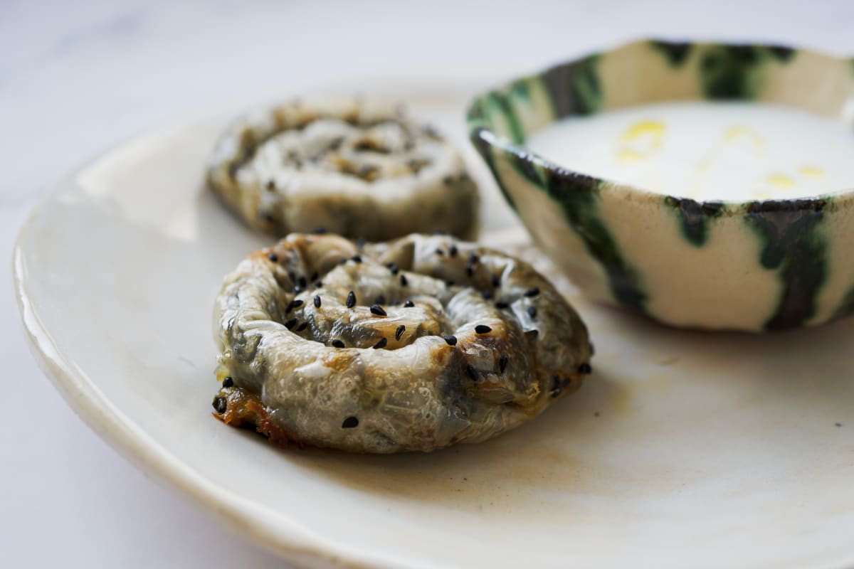 burrekas snails next to a yogurt bowl