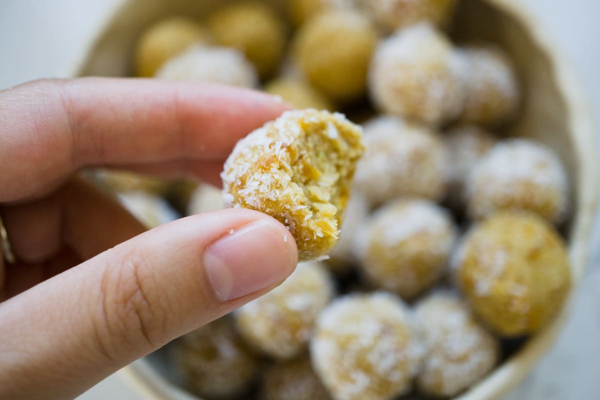 holding one Mango Lime Coconut Protein Ball