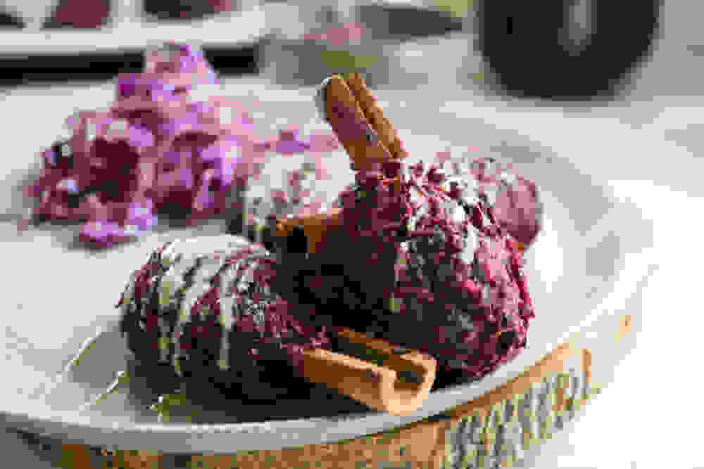 vegan beet kebab on cinnamon sticks with tahini and red cabbage salad
