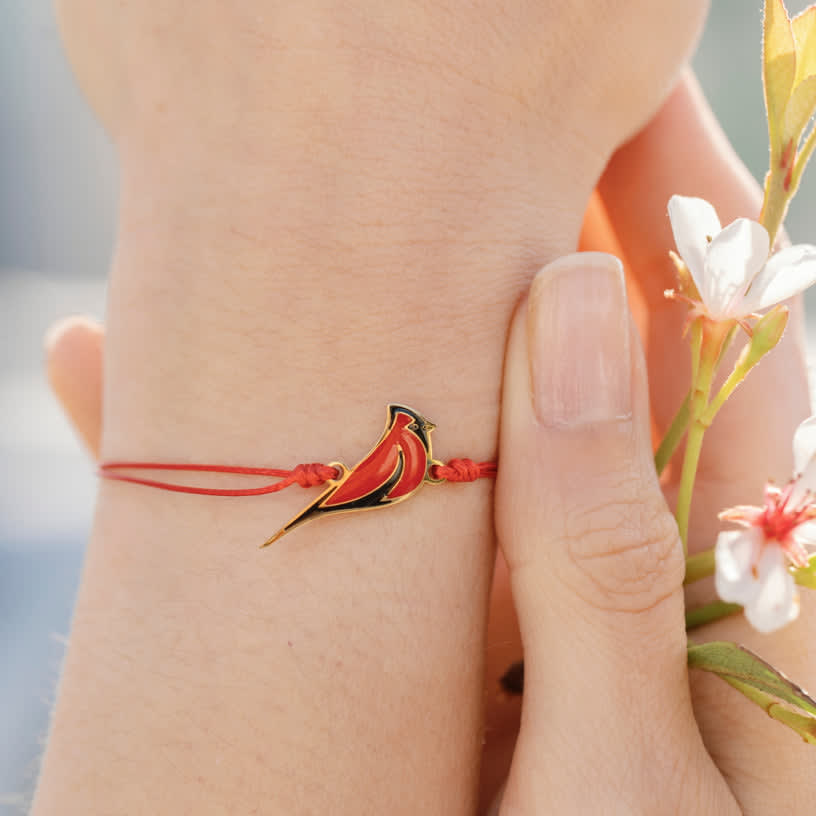 Red cardinal bracelet worn on a wrist