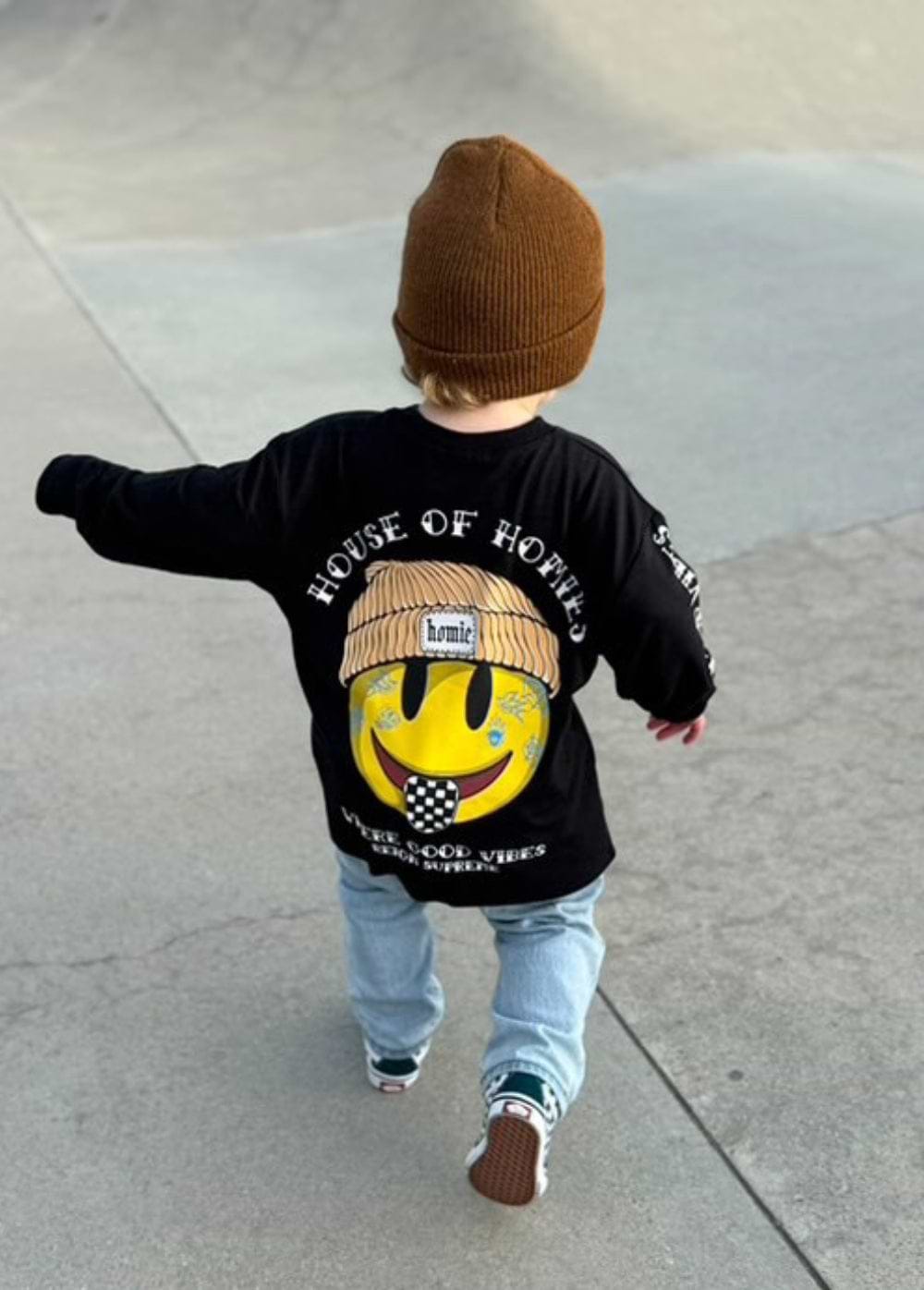Child in a yellow beanie and patterned-pants fall look