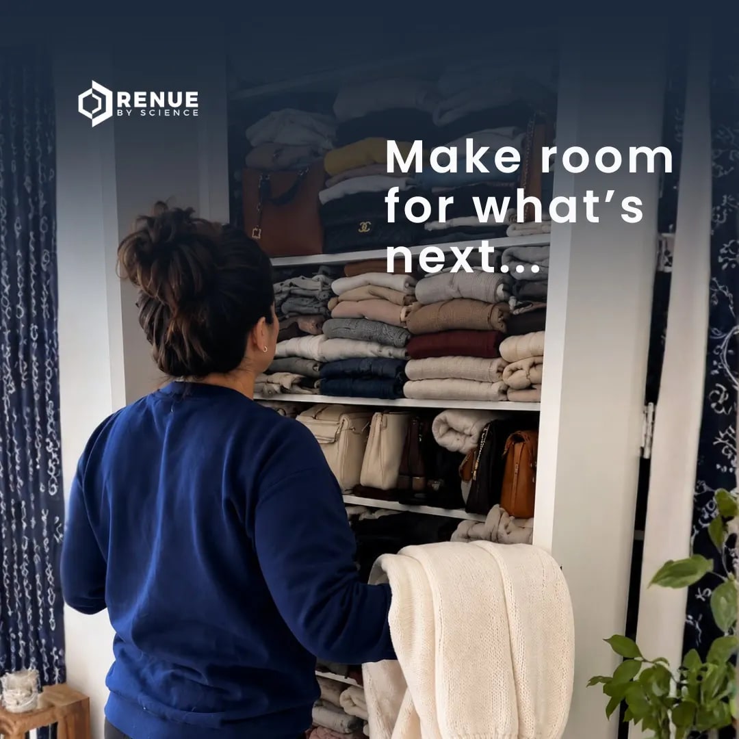Mature woman sorting clothes from a crowded bedroom wardrobe