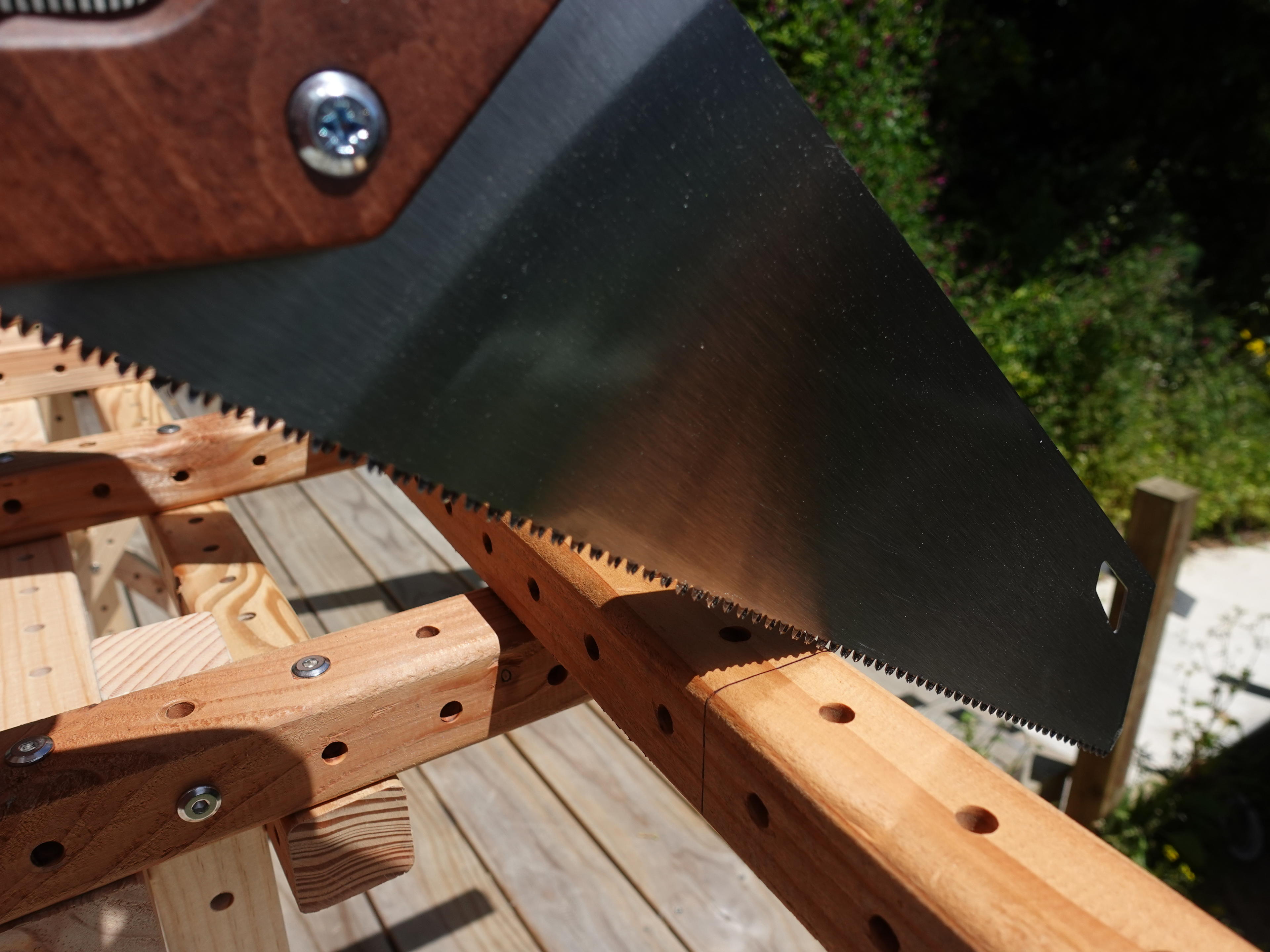 Person lining the saw blade up with the cut line.