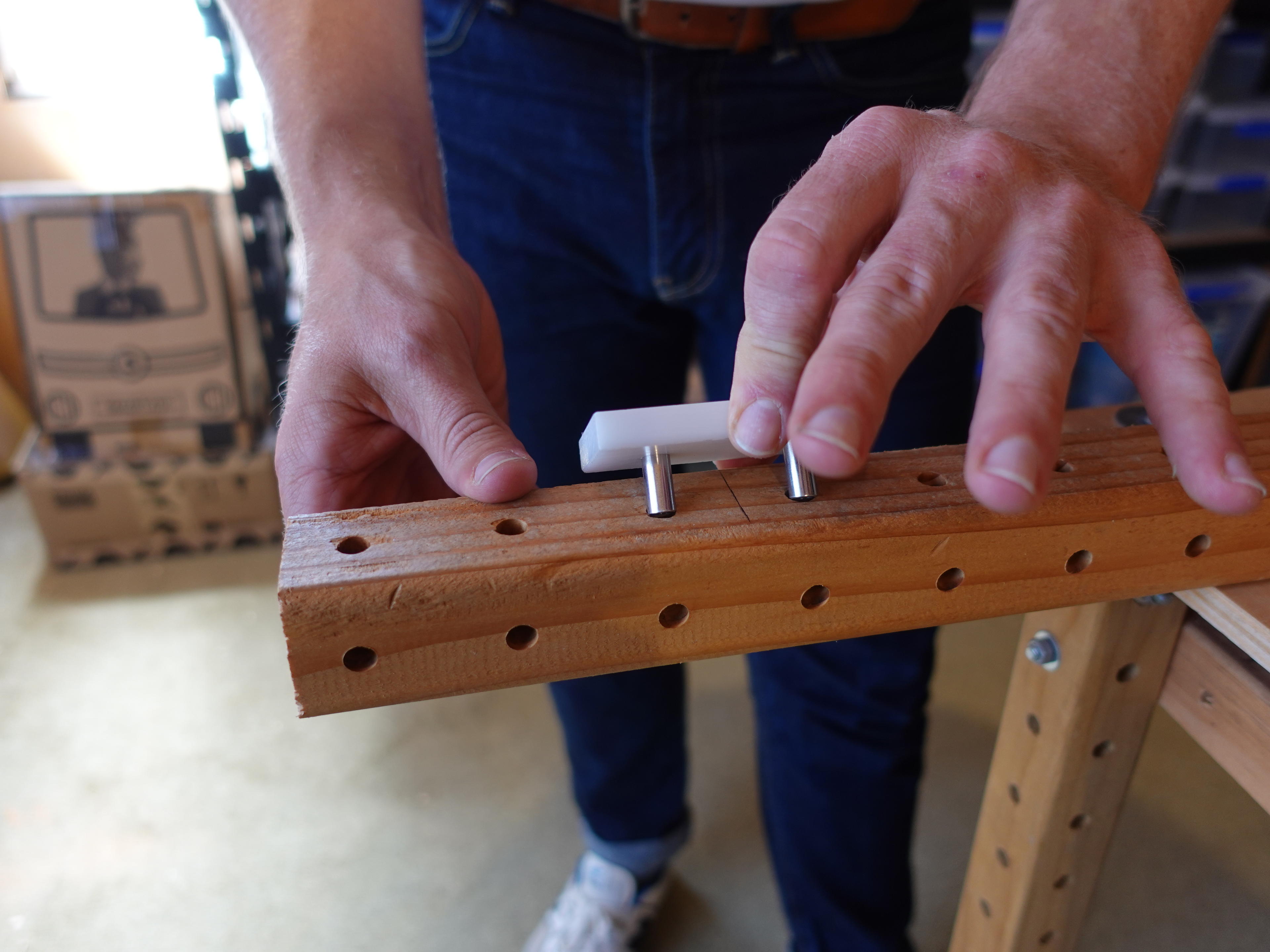 Photo of person placing cut alignment tool into beam holes