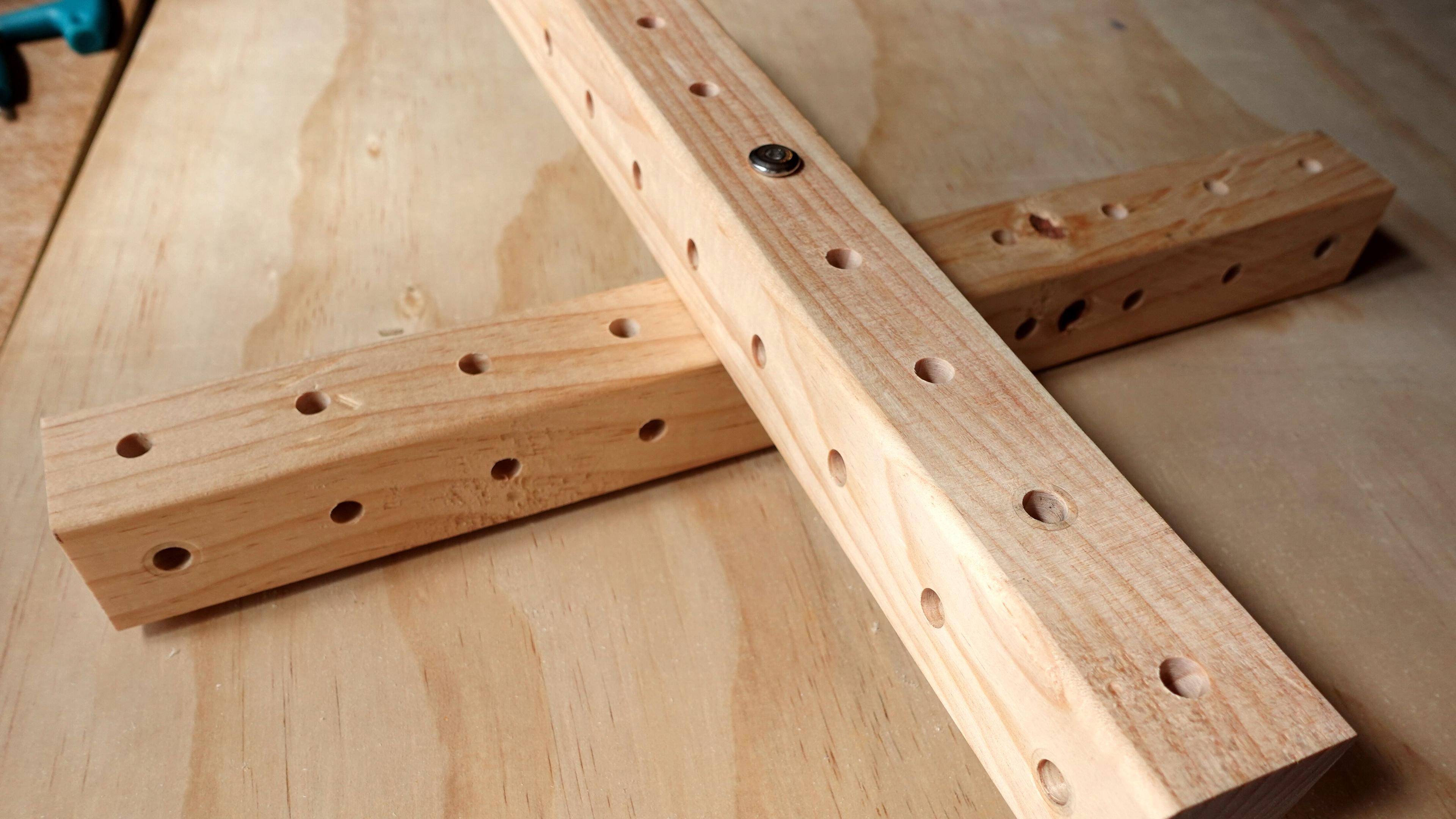 Close-up of two wooden beams connected by a bolt. The bolt head and a nut are visible, securing the connection between the beams.