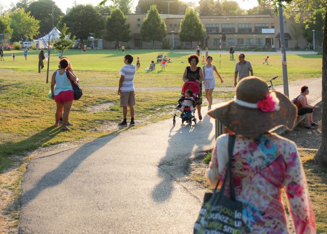 Citizens walking in a sunny park
