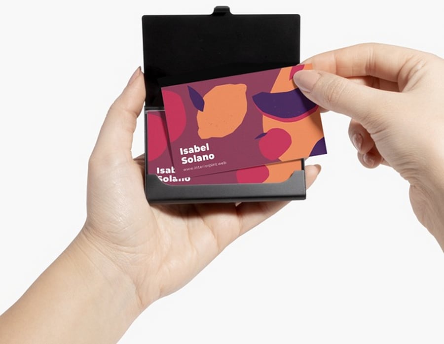 Business cards stored in an aluminum business cards holder