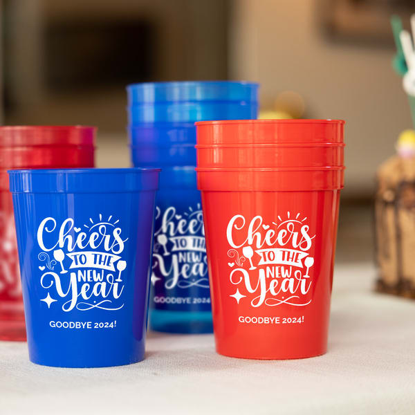Red and blue custom party cups printed with a “Cheers to the New Year” design.