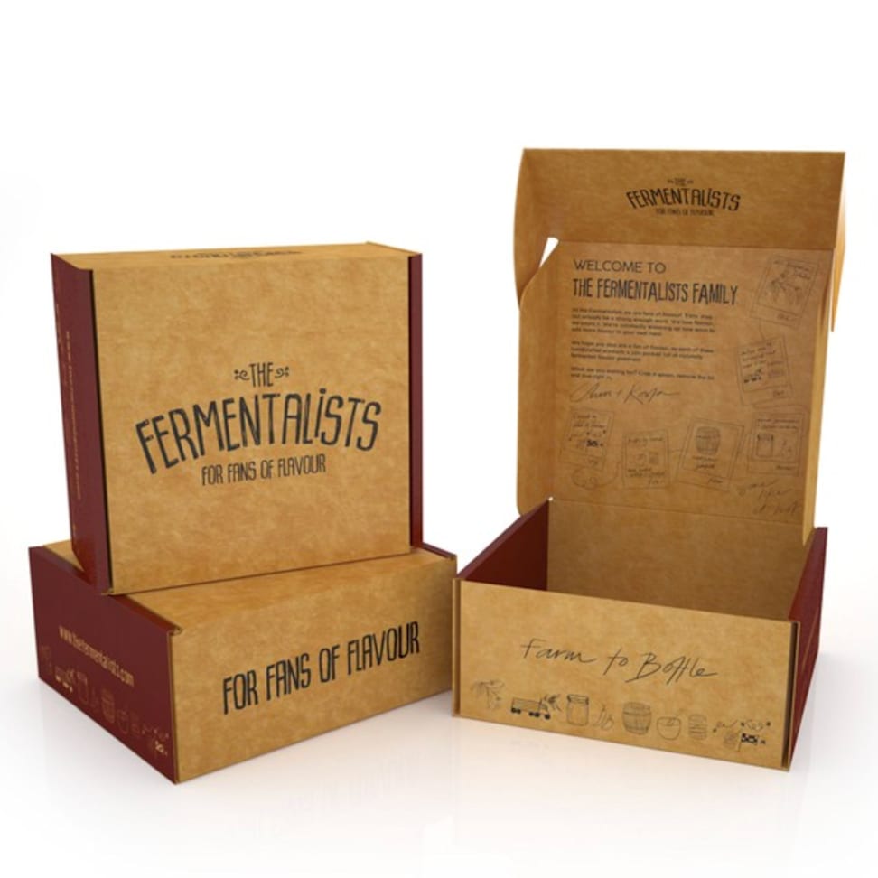 Selection of rustic looking brown recycled cardboard mailer boxes with simple organic style black font and designs