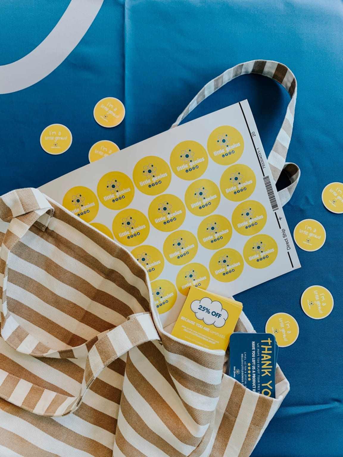 A sheet of round yellow branded stickers with the brand logo and social media icons