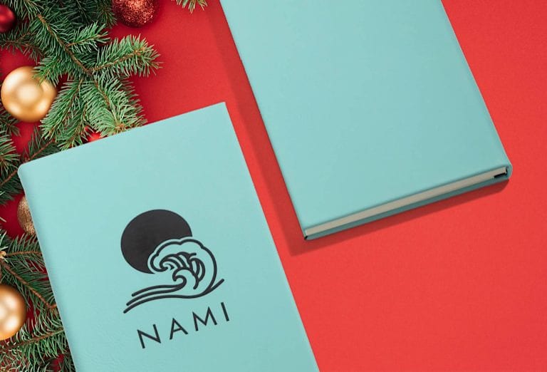 Blue notebook with black text and branded graphic.