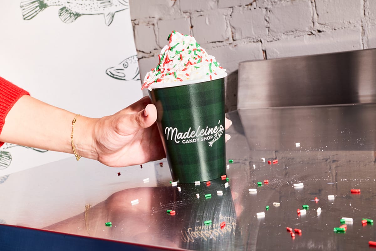 Festive drink served in a branded paper cup at an in-store holiday event