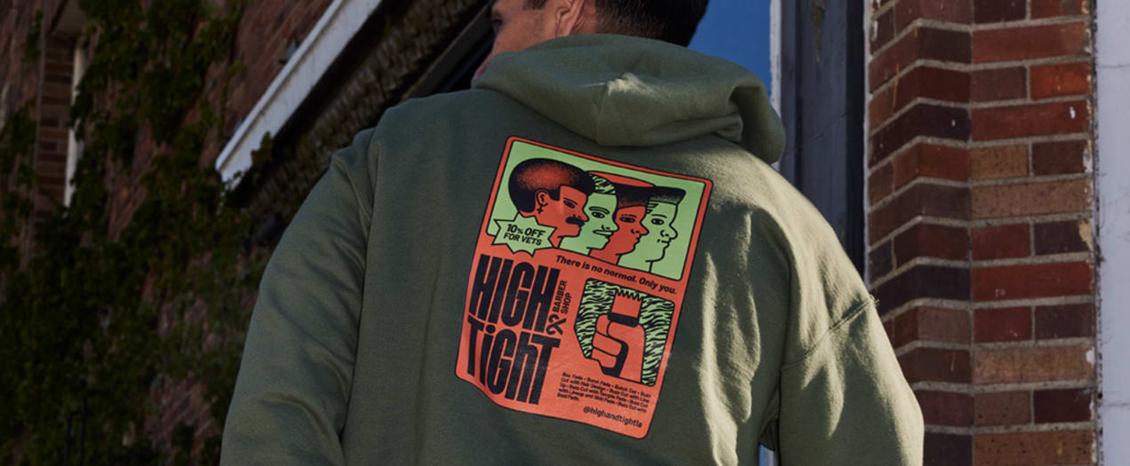 A dark green hoodie with a red and green illustrated back graphic print