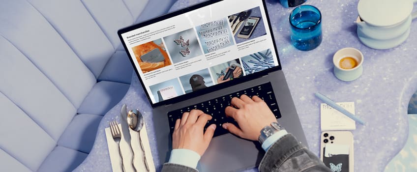 Hands on a laptop keyboard viewing a website selling branded merchandise