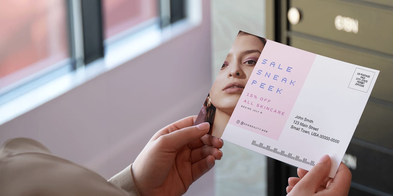 Person holding cosmetic business postcard promoting 15% off all skincare
