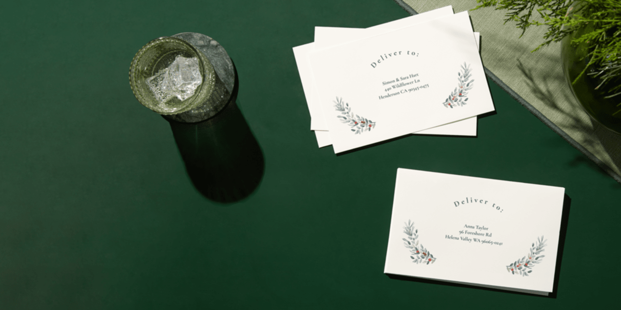 A stack of branded envelopes on a green background