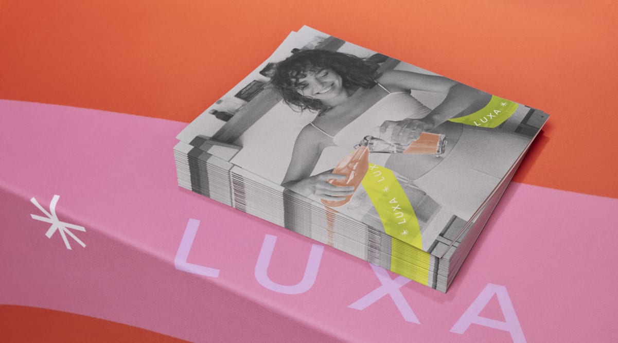 A stack of branded bi–fold brochures for a drinks company