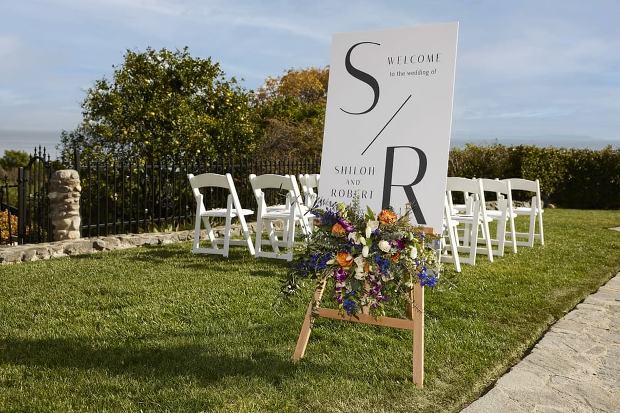 Outdoor Wedding Ceremony Setup with Elegant Welcome Sign