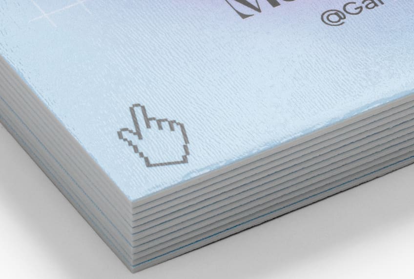 Close-up of a stack of pale blue business cards with a cursor icon and textured paper finish.