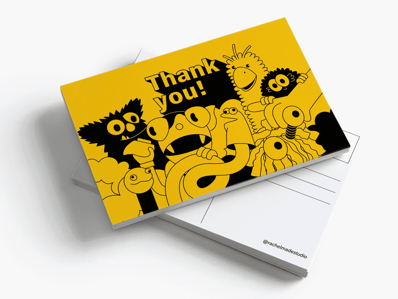 Stack of yellow thank you postcards with illustrations of monsters