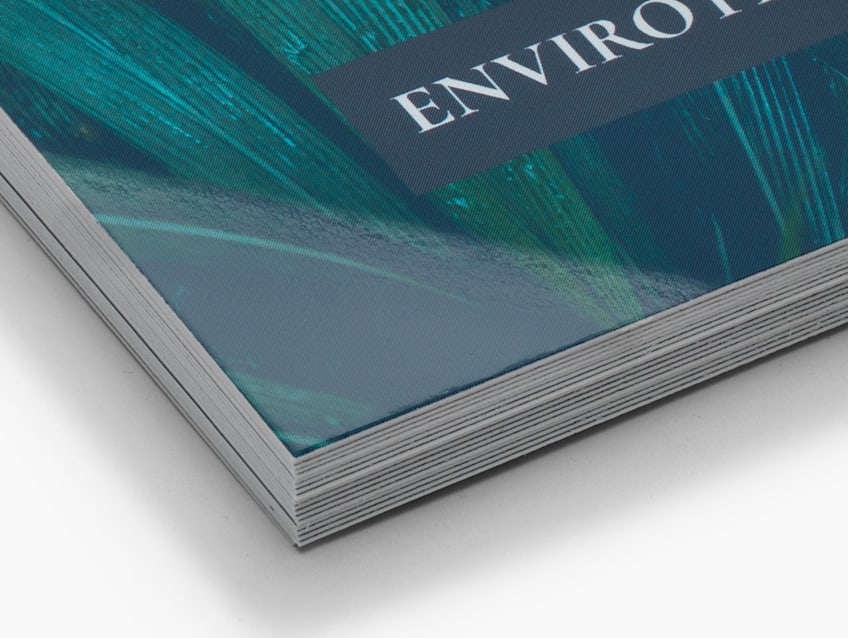 Close up of a stack of glossy business cards with a blue and green pattern