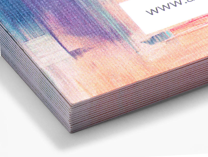 Stack of colored linen business cards with a business URL printed on