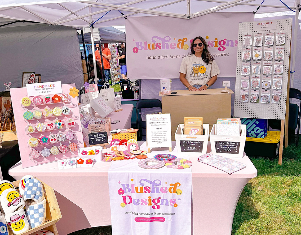 Small business owner and stall at a trade show event with products and multi-colored signage