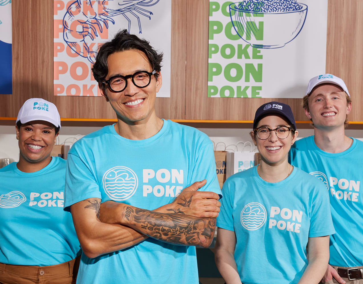 A team wearing branded T-shirts printed for a poke restaurant