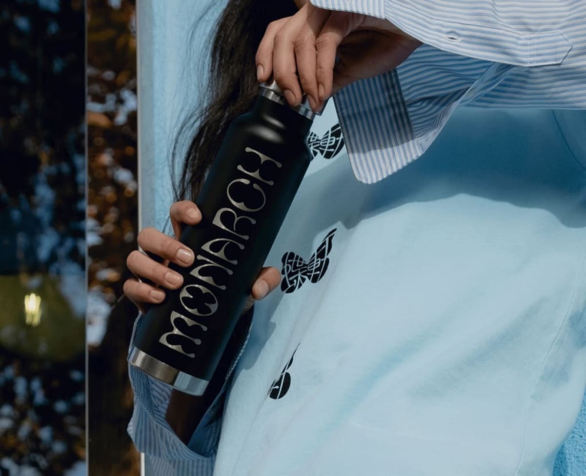 A loyal customer opening a black customized water bottle
