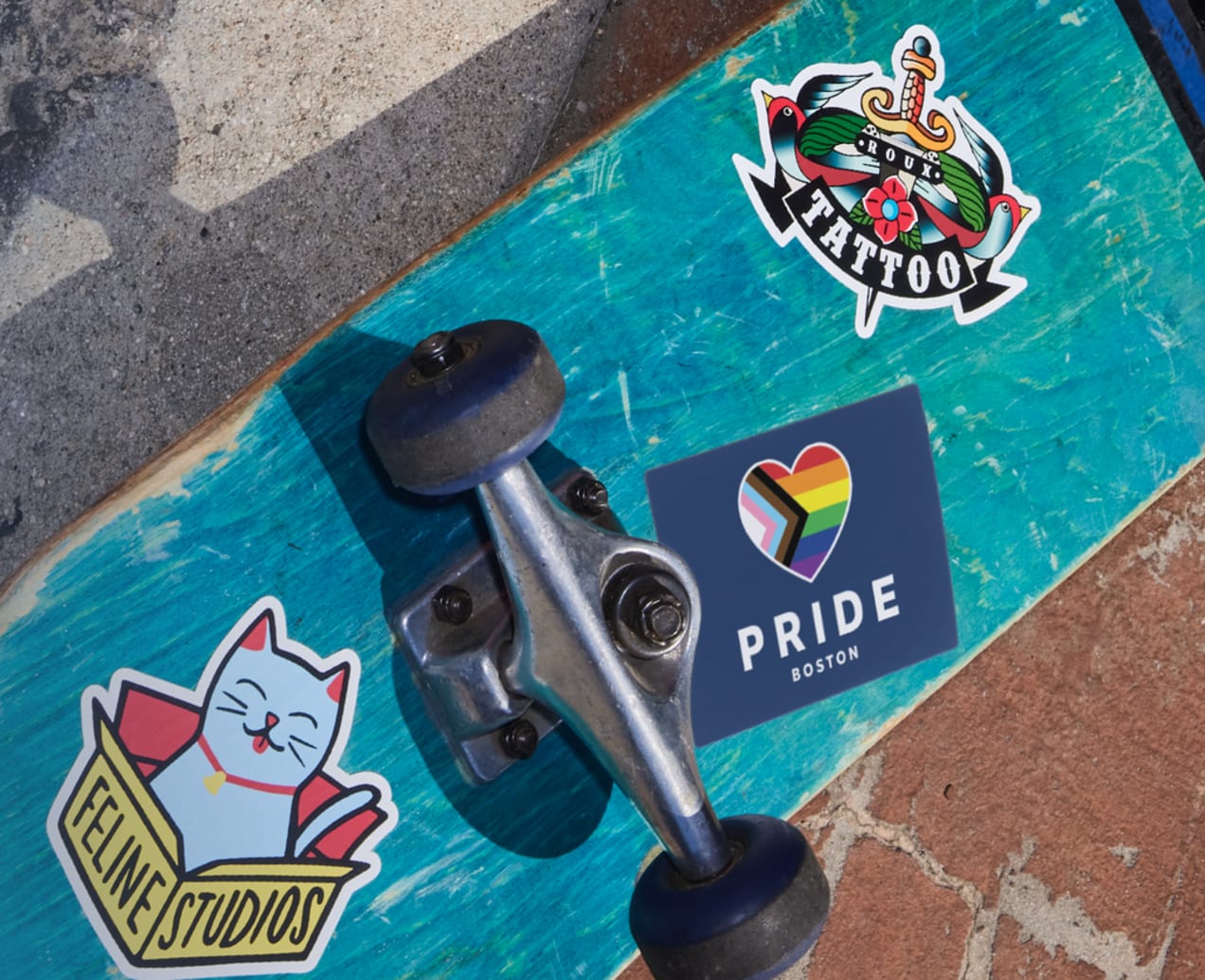 Permanent adhesive stickers applied to the bottom of a skateboard