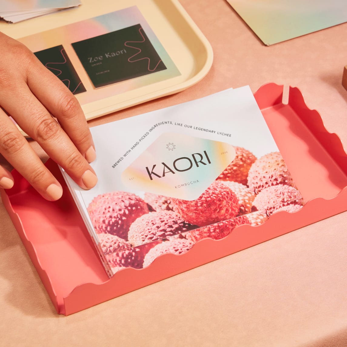 Kombucha brand logo printed on marketing postcards