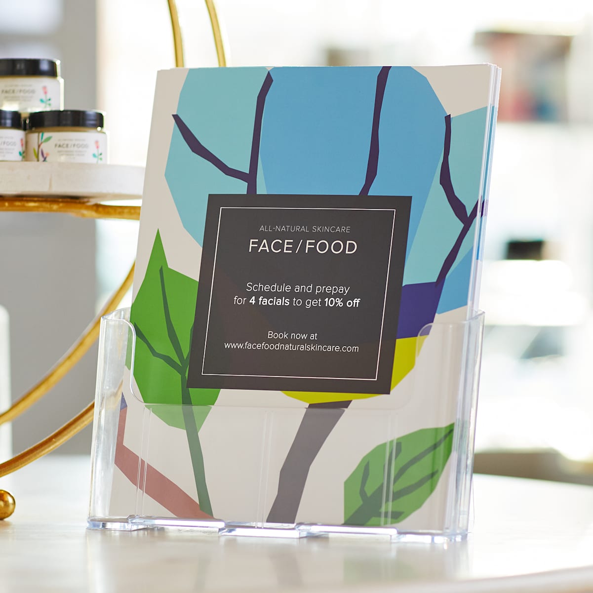 A stack of matte paper stock flyers for a beauty services business