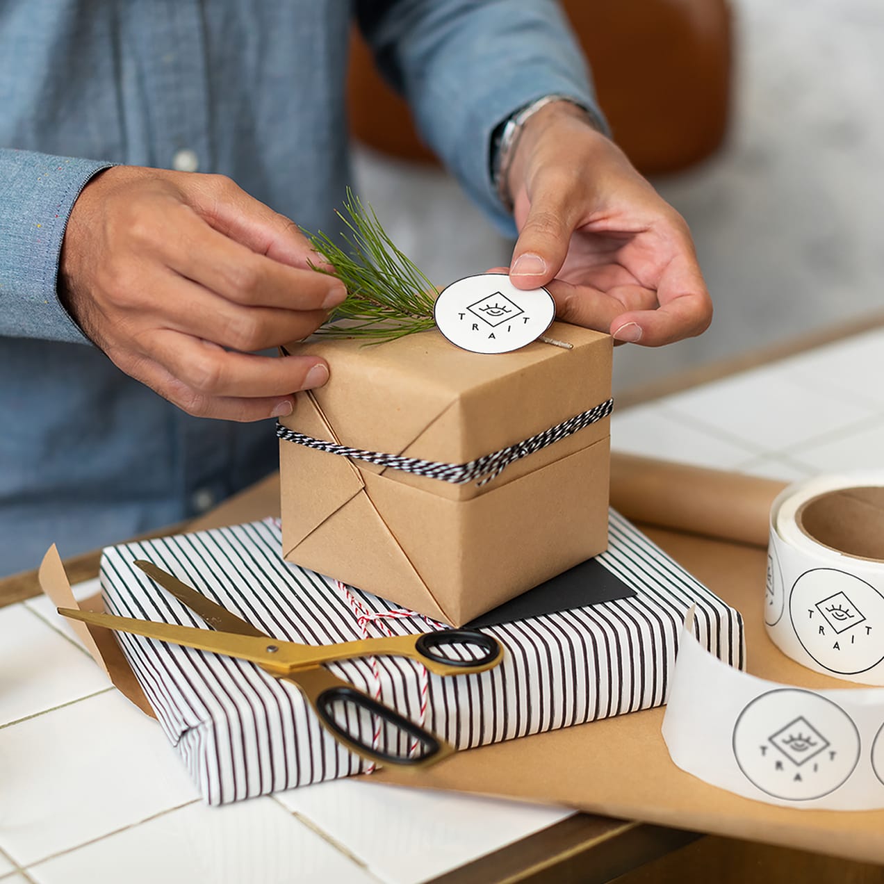 A person applying a branded paper sticker on the packaging
